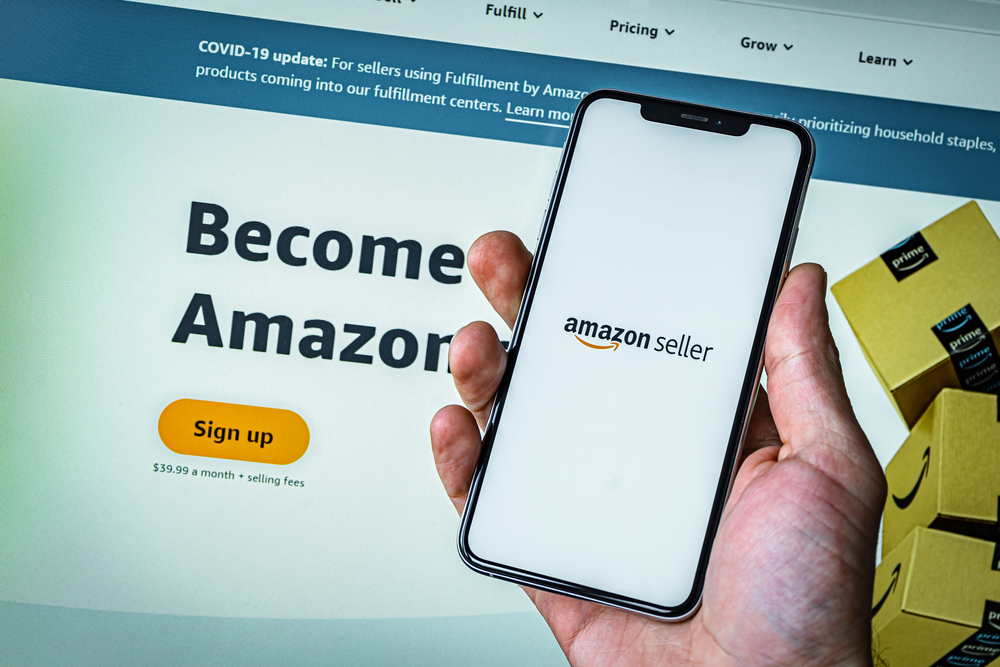 Man holding phone saying Amazon seller, featured image.